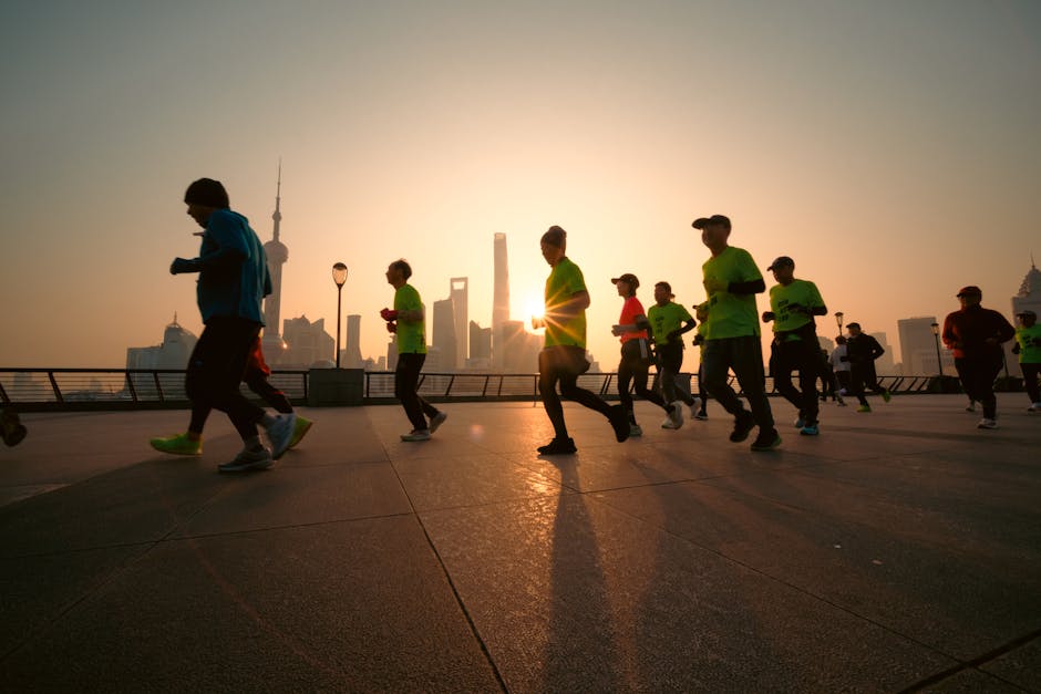 A group of runners silhouetted against a beautiful sunrise in Shanghai, China.