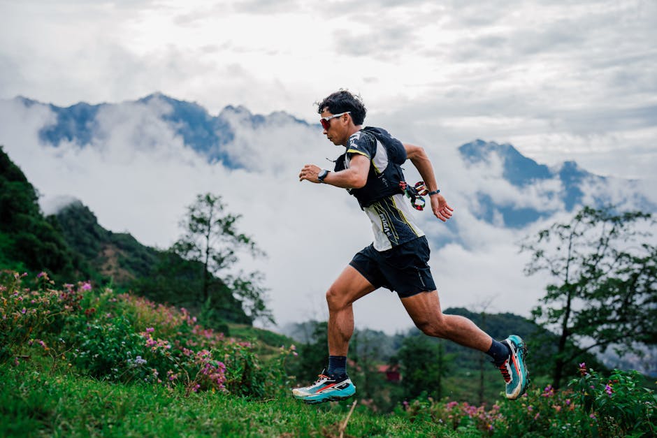 A runner dashes through a misty mountain trail, showcasing endurance and nature's beauty.
