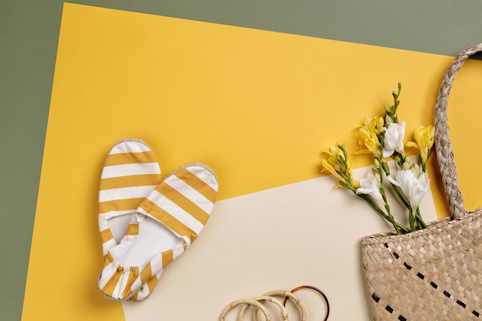 Flat lay of striped shoes, freesias, and straw bag on colorful background for summer.