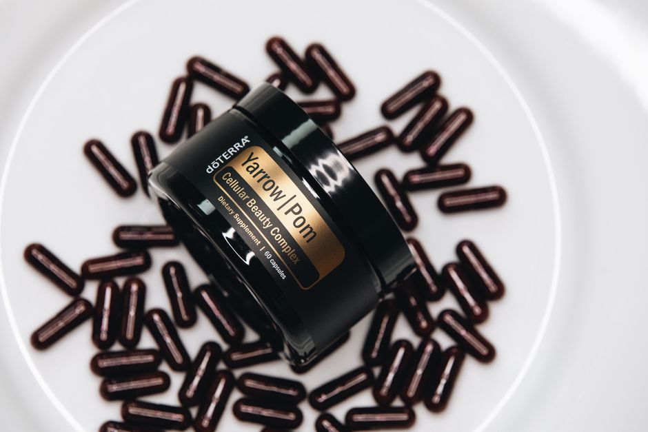 High-quality image of doterra Yarrow Pom Cellular Beauty Complex with capsules on a plate.