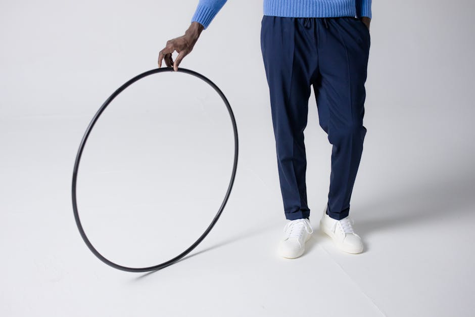 Creative minimalist image showing a person holding a hula hoop in a studio setting.