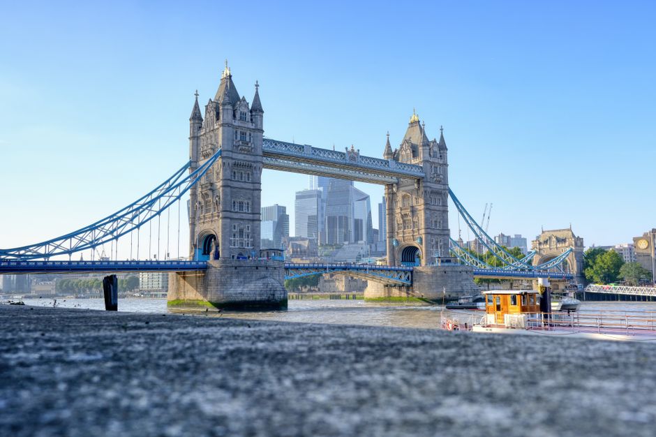 Iconic Tower Bridge spanning the River Thames in London with a clear summer sky.
